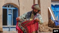 An Afghan man salvages his possessions from his partially submerged home following flash flooding that struck in the Guzara district of Herat Province on March 13.&nbsp;<br />
<br />
At least 60 people have been killed by weeks of heavy rain and snow in Afghanistan over the past three weeks, the government&#39;s Disaster Ministry said.&nbsp;