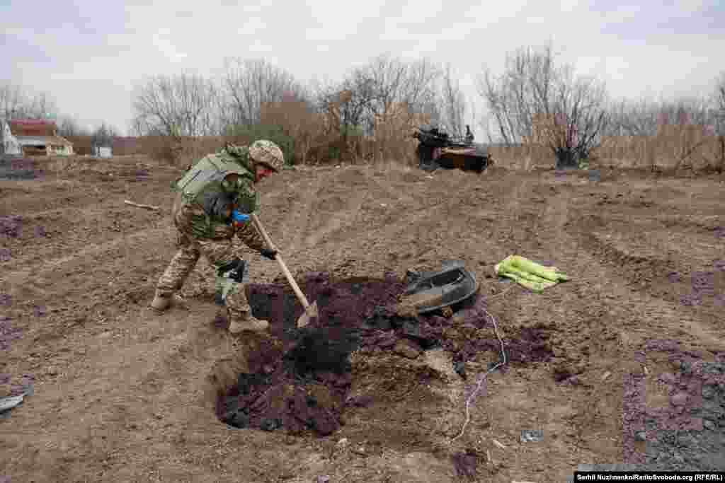 Imaginea 1: Un soldat ucrainean sapă un mormânt pentru un soldat rus ucis în Lukianivka, martie 2022. Imaginea 2: Locul a fost acoperit de vegetație, martie 2024.