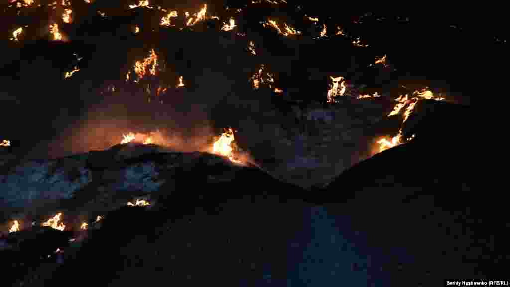 A fire is seen at a storage facility for sunflower oil after a Russian air strike in Yakovlivka, in the Donetsk region, in May 2022. The village was later razed to the ground and occupied by Russian forces.