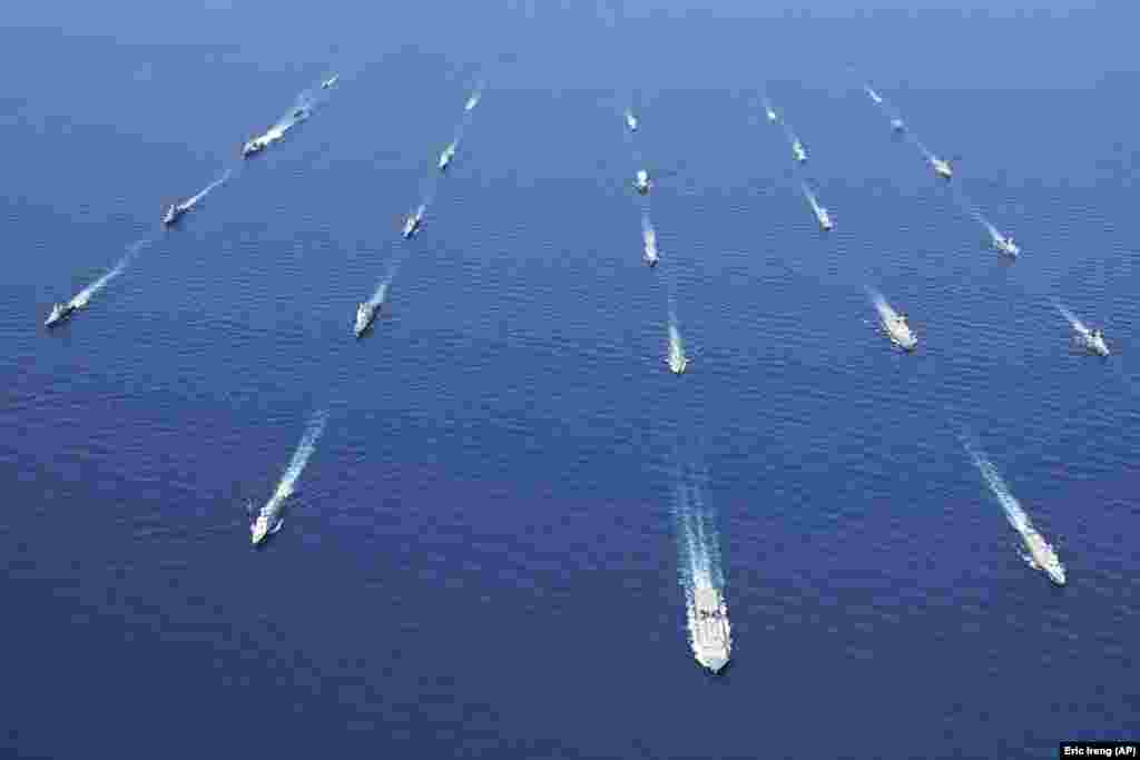 War ships sail in formation during the closing of an international exercise involving navies from more than 30 countries, including the United States, Russia, Britain, Japan, China, Brazil, India, and South Korea. The noncombat&nbsp; drills were held amid tensions in the Asia-Pacific region.&nbsp;