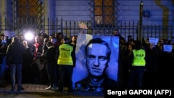 Demonstrators hold a portrait of Russian opposition leader Aleksei Navalny during a rally in front of the Russian Embassy in Warsaw on February 16. 