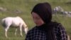Mountain Visocica, Bosnia and Hercegovina, girl Dzenana spends her summer vacation looking after sheep with her father 