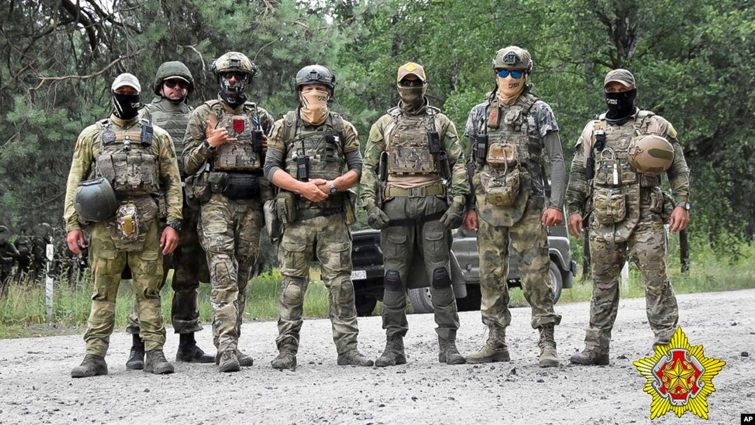 In a photo released by Belarus's Defense Ministry on July 20, Belarusian special forces and mercenaries pose during maneuvers near the border city of Brest. 