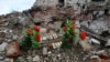 A makeshift memorial for civilian residents killed in Russian attacks is seen near a destroyed residential building in Izyum on February 20.