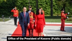 Kosovar President Vjosa Osmani (right) walks with Albanian President Bajram Begaj during her official visit to Tirana on September 4.