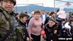 Karabakh civilians take shelter at a Russian military base.