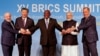 (Left to right) Brazilian President Luiz Inacio Lula da Silva, Chinese President Xi Jinping, South African President Cyril Ramaphosa, Indian Prime Minister Narendra Modi, and Russian Foreign Minister Sergei Lavrov pose for a family photo during the BRICS summit in Johannesburg, South Africa, on August 23. 