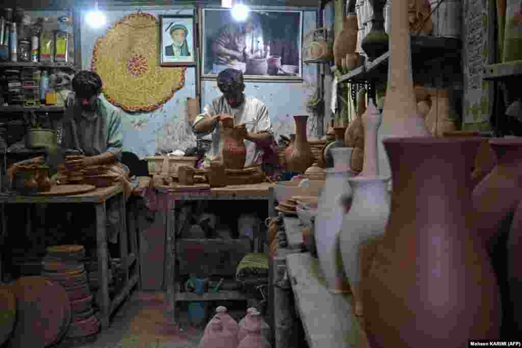 Afghan potters work inside a clay pot factory in Herat.