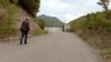 Stanimir Jovanović walking to concrete wall that the Kosovo Police erected on the territory of the municipality of Leposavic