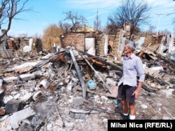 Constantin Gavrilescu photographed in early September alongside his destroyed house.