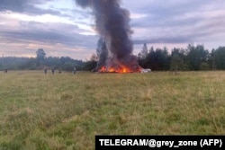 This photograph posted on a Wagner-linked Telegram channel on August 23 shows burning plane wreckage near the village of Kuzhenkino in Russia's Tver region.