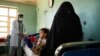 A doctor talks with a patient and her child at the Tangi Saidan clinic run by the Swedish Committee for Afghanistan in the Daymirdad district of Wardak Province.