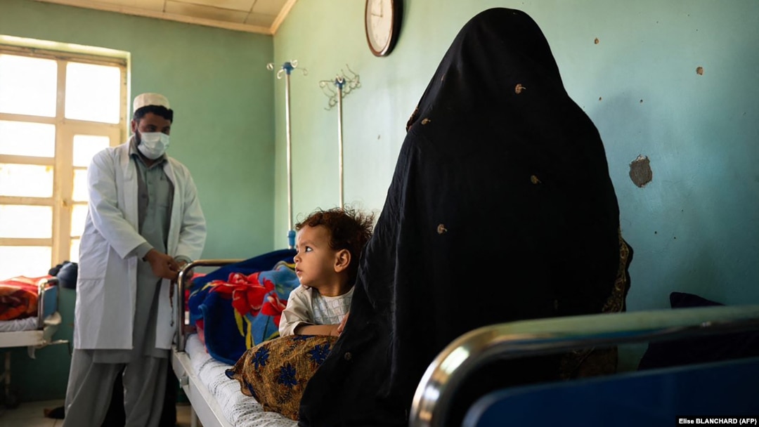 A doctor talks with a patient and her child at the Tangi Saidan clinic run by the Swedish Committee for Afghanistan in the Daymirdad district of Wardak Province.