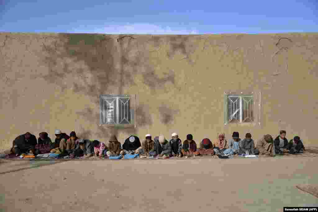 Children learn the Koran outside a mosque in the Zhari district of Kandahar Province.