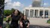 A family runs from an explosion after a Russian missile strike on a residential neighborhood in Pervomayskiy, in Ukraine's northeastern Kharkiv region, on July 4.