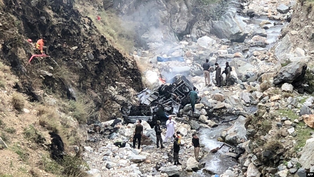 Security officials inspect the wreckage of a vehicle that was carrying Chinese nationals and plunged into a ravine after a suicide attack near Besham city in the Shangla district of Khyber Pakhtunkhwa Province on March 26.

