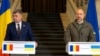 Romanian Prime Minister Marcel Ciolacu (left) and Ukrainian Prime Minister Denys Shmyhal address a press conference in Kyiv on October 19.