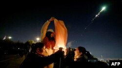 Iranian women light a lantern on the eve of the Wednesday Feast&nbsp;in Tehran on March 12, ahead of Norouz, the Persian New Year, which begins on March 20 and coincides with the first day of spring.<br />
<br />
The celebrations have arrived in an atmosphere of growing frustration with the clerical establishment as a historically low turnout marred a March 1 parliamentary election.<br />
<br />
&nbsp;