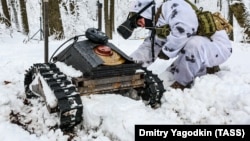 A Russian soldier tests a ground drone in Ukraine's Donetsk region in February. 