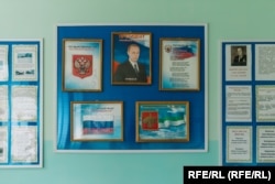 A portrait of young Vladimir Putin, from the time of his first presidential term, hangs in the foyer of Kuratovo's school.