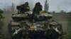 A Ukrainian tank rides along a road toward position near Bakhmut on June 17.