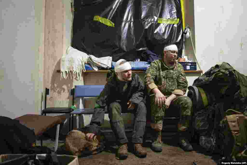 Ukrainian soldiers who were wounded on the battlefield wait to leave the field hospital.