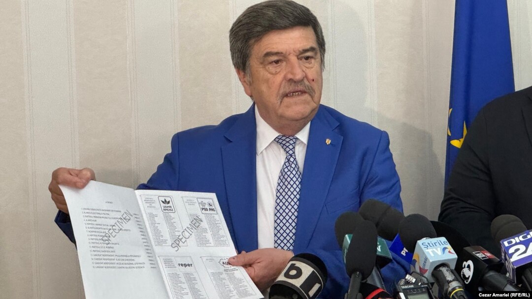 Toni Greblă, președintele Autorității Electorale Permanente din România, arată un model de buletin de vot care va fi folosit la alegerile din 9 iunie