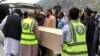 Volunteers transport the coffins of a Chinese national from a hospital following a suicide attack the Shangla district of Khyber Pakhtunkhwa Province on March 26.