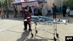 An injured Afghan man is brought to a hospital following an earthquake in Herat Province earlier this month.