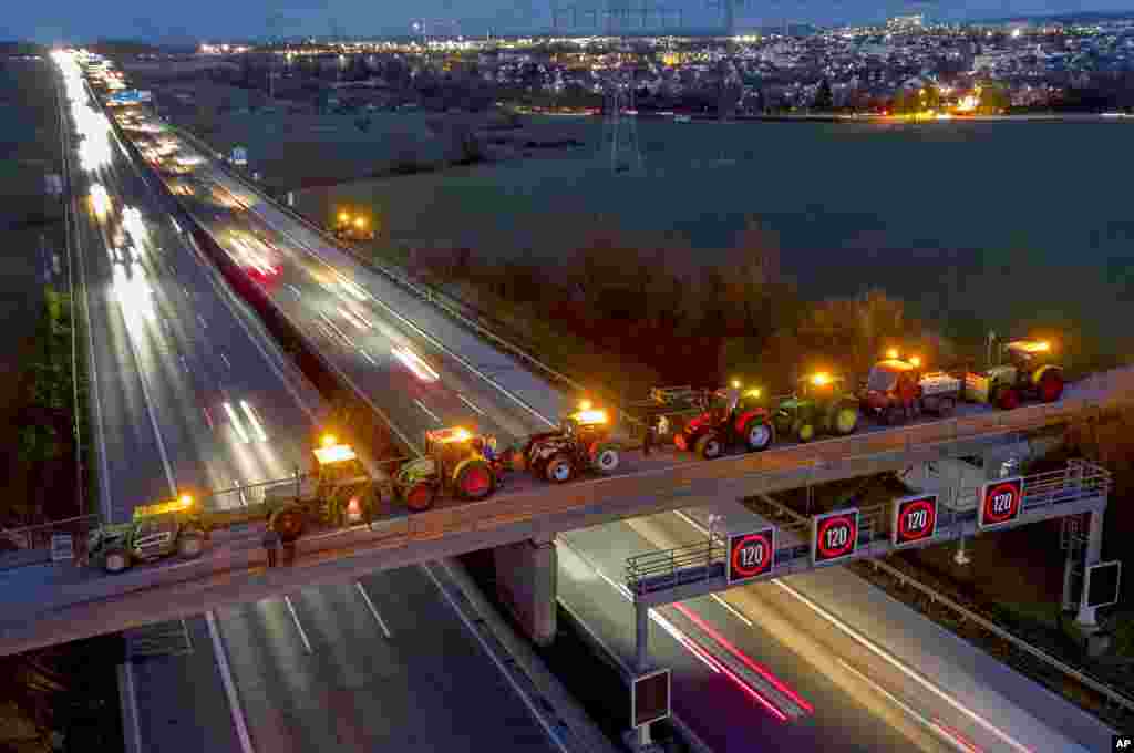 Traktorë të parkuar në një urë mbi një autostradë në Frankfurt, Gjermani.