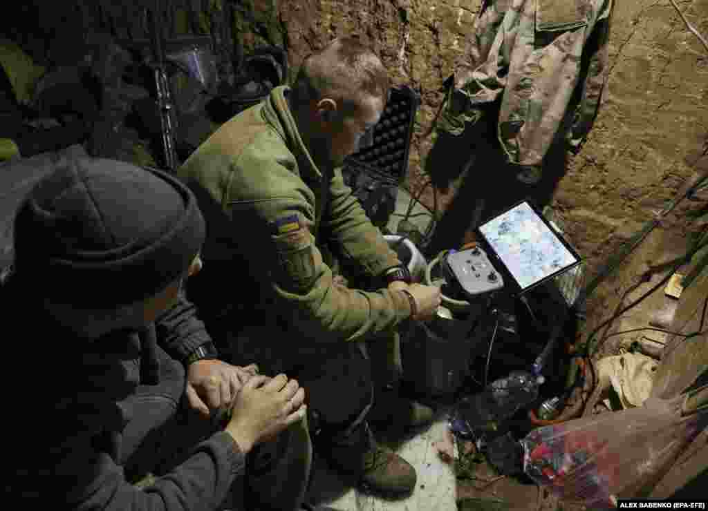 A Ukrainian operator watches a drone&#39;s progress on a small monitor at an undisclosed location on June 28. As inexpensive drones become more advanced, they are increasingly being integrated into the overall military structure on both sides.&nbsp; &nbsp;