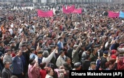 Kyrgyz opposition protesters shout slogans against then-President Askar Akaev as they rally in Bishkek in March 2005.