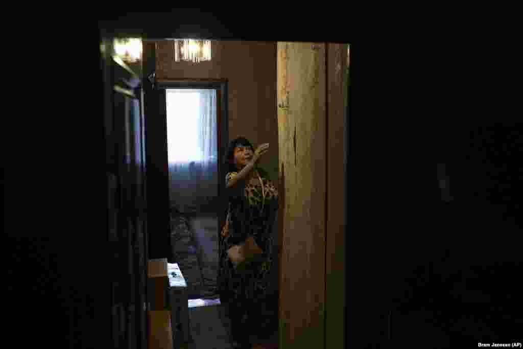 Iryna Solodka turns off the lights inside her house after agreeing to be evacuated.&nbsp;