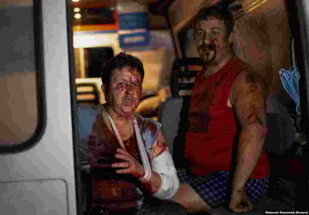 Natasha and Oleksandr, who were injured during the Russian missile strike, wait for news of her daughter in the back of an ambulance. &quot;A rocket came in from over there; who knows? I was standing in the kitchen,&quot; Natasha said.