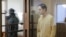 Wall Street Journal reporter Evan Gershkovich stands behind the glass wall of a defendants' cage before a court hearing to consider an appeal against his pretrial detention on espionage charges in Moscow on September 19.