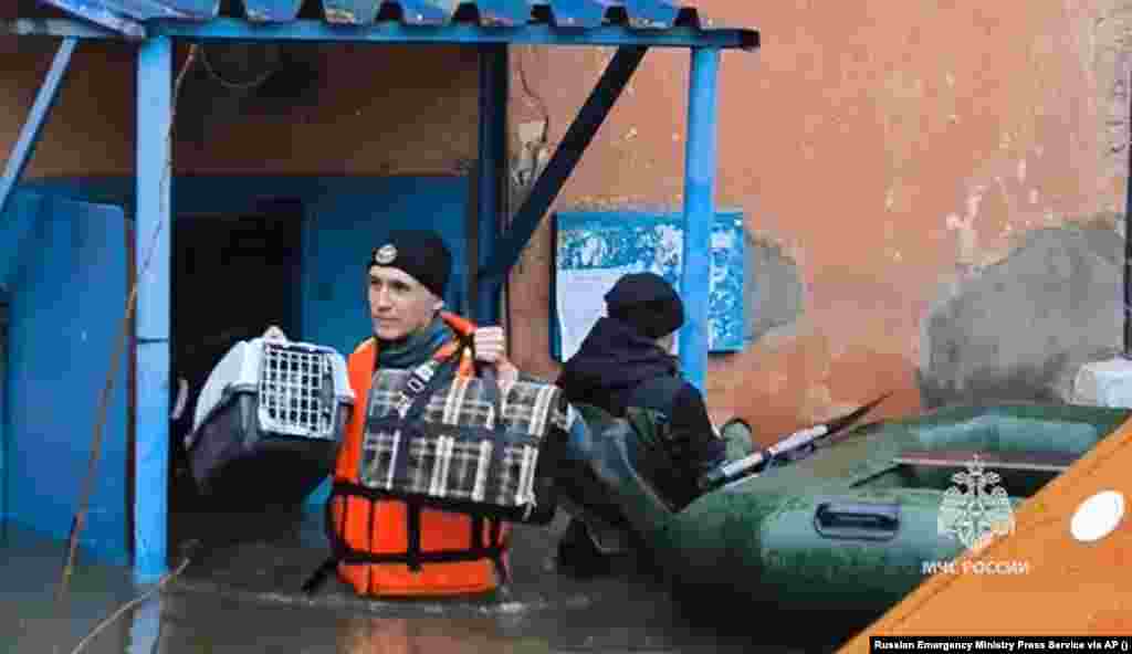 A video grab released by Russia&#39;s Emergency Situations Ministry shows workers rescuing personal belongings and pets from homes in Orsk, where floodwaters reached first-floor windows on April 7. In response to a devastating dam breach that has submerged more than 10,000 homes, Russian authorities have declared a federal emergency in flood-hit areas.&nbsp; &nbsp;