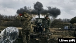 Ukrainian soldiers fire a howitzer toward Russian positions near Bakhmut, the site of the heaviest battles, in the Donetsk region on March 7.