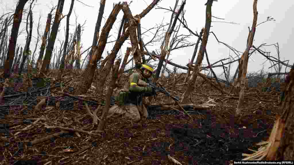 As the sounds of machine-gun fire and explosions rang out, another Ukrainian soldier slowly advanced in a half-crouched position toward the enemy.