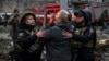 A woman reacts in front of a partially destroyed residential building after an air strike in Slovyansk on April 14.