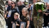 Relatives of former Ukrainian deputy Iryna Farion carry her photo during her funeral procession in Lviv on July 22. Farion died after an unknown gunman shot her on July 19. She was known for campaigns to promote the Ukrainian language.