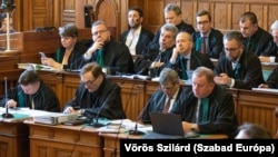 Defense lawyers attend a trial of one of the largest recent corruption cases in Hungary in Budapest on February 17.