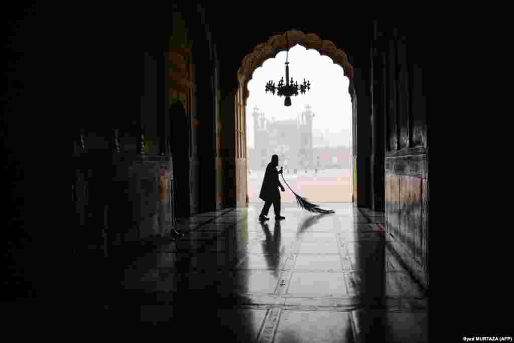 A Muslim man cleans a corridor at the Badshahi Mosque ahead of the Islamic holy fasting month of Ramadan in Lahore, Pakistan, on March 11.