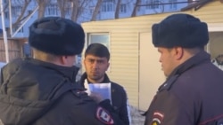 Russian police confront a Central Asian migrant. 
