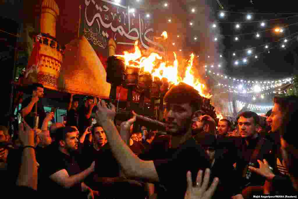 Iranian Shi&#39;ite Muslims in Tehran perform a torch procession during a mourning ritual ahead of Ashura, the holiest day in the Shi&#39;ite Muslim calendar.