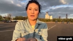 Журналист Диана Сапаркызы ведёт съёмку у шахты «Казахстанская», где подверглась нападению. Скриншот из видео 
