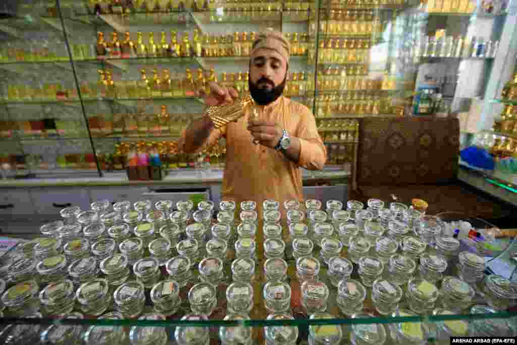 &nbsp;A man sells nonalcoholic perfumes at a shop during the fasting month of Ramadan in Peshawar, Pakistan.