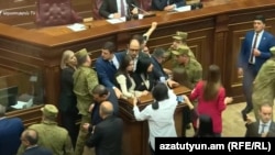 Armenia - Security guards use force against oppositon deputies occupying the parliament rostrum, April 20, 2023.
