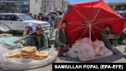 Afghan vendors sell bread on a roadside in Kabul.