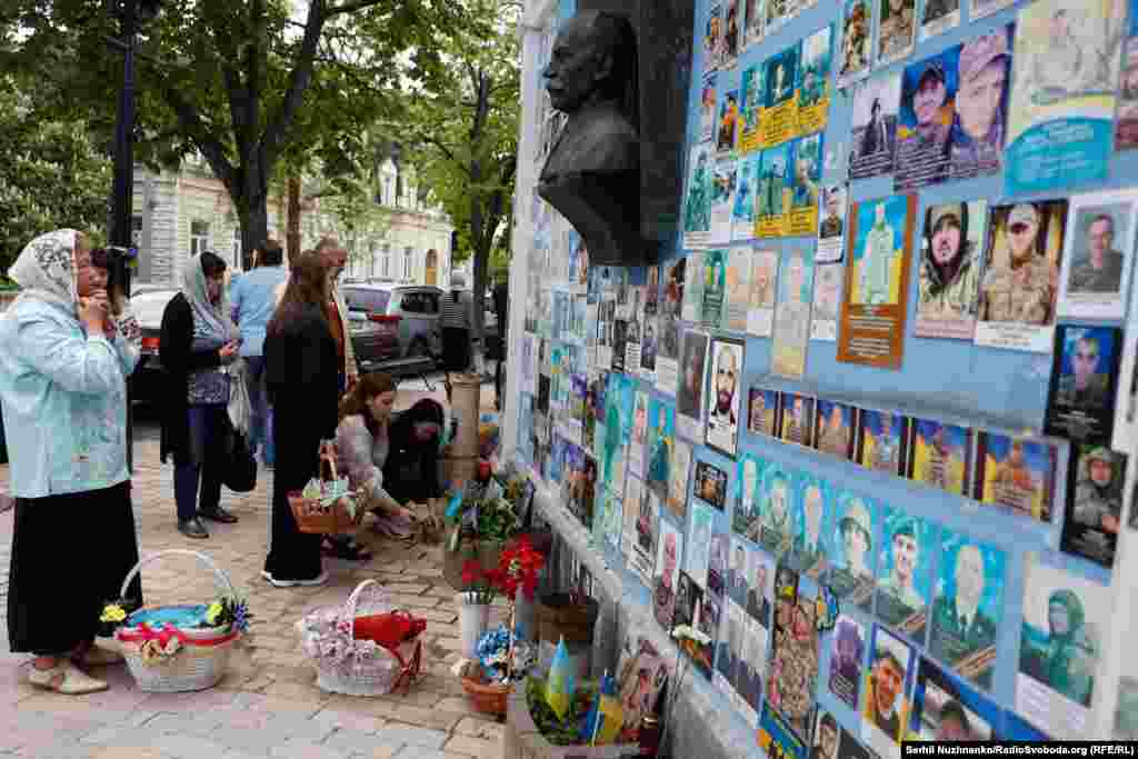 After the religious ceremonies, family members stopped by to pay their respects at the Memory Wall of the Fallen Defenders of Ukraine.