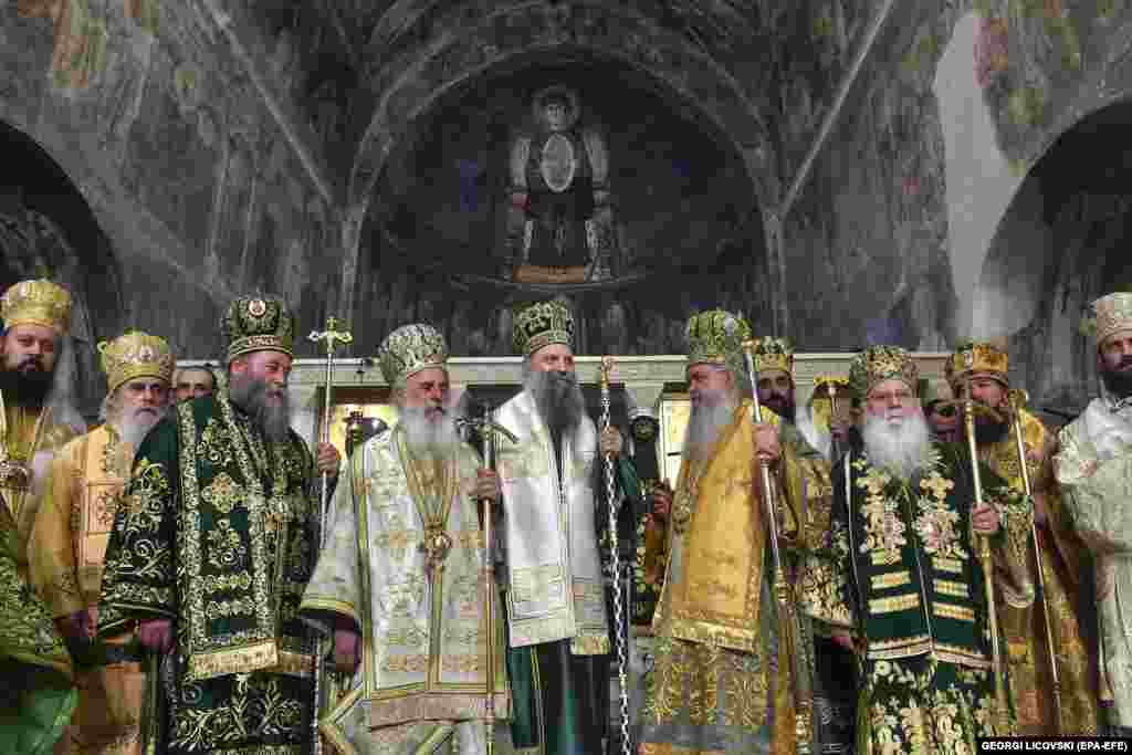 The head of Macedonian Orthodox Church, Archbishop Stefan, (center right) and the head of the Serbian Orthodox Church, Patriarch Porfirije (center), stand alongside bishops from North Macedonia and Serbia after a joint liturgy at the Church of Saint Sophia in Ohrid, North Macedonia.